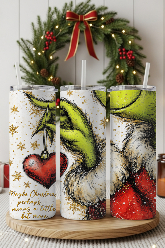 Mischievous green Christmas character on a stainless steel tumbler.

